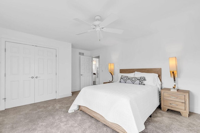 bedroom with light carpet, a closet, and ceiling fan