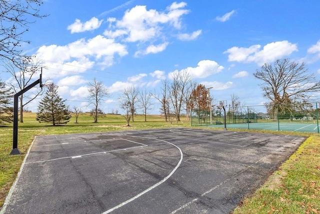 view of basketball court featuring a lawn and tennis court