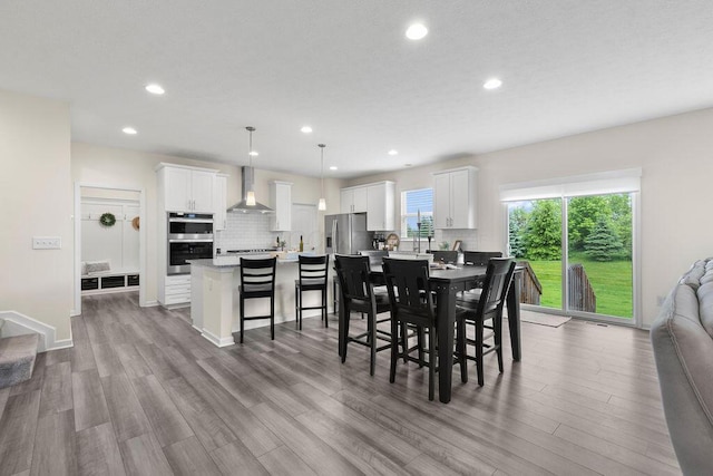 531 White Fawn Run, Delaware, OH 43015 - dining room with recessed lighting, wood finished floors, and stairs