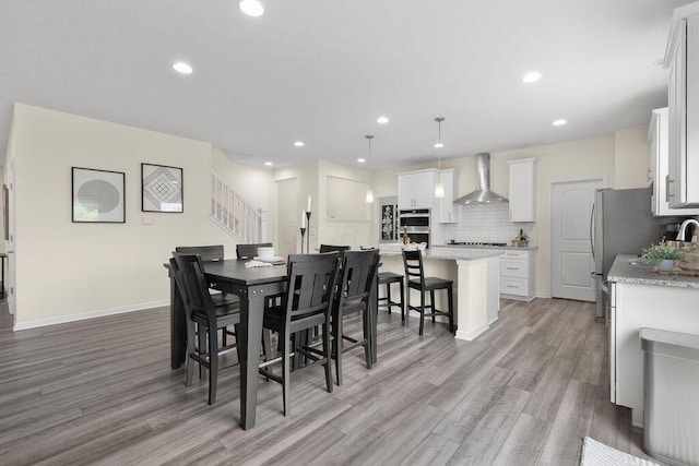 531 White Fawn Run, Delaware, OH 43015 - dining area with light wood finished floors, recessed lighting, baseboards, and stairway