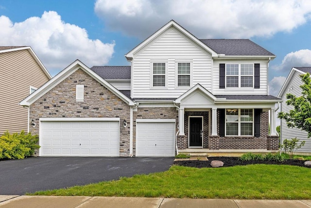 531 White Fawn Run, Delaware, OH 43015 - view of front of house with driveway, a garage, a porch, and a front yard