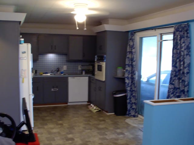 kitchen featuring dishwasher, refrigerator, sink, tasteful backsplash, and wall oven