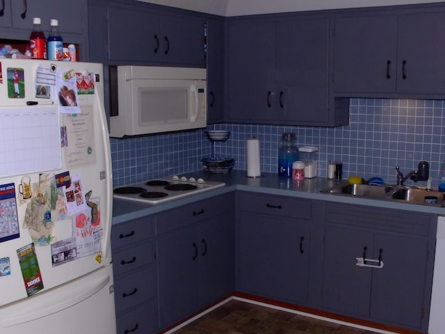 kitchen with tasteful backsplash, sink, and white appliances