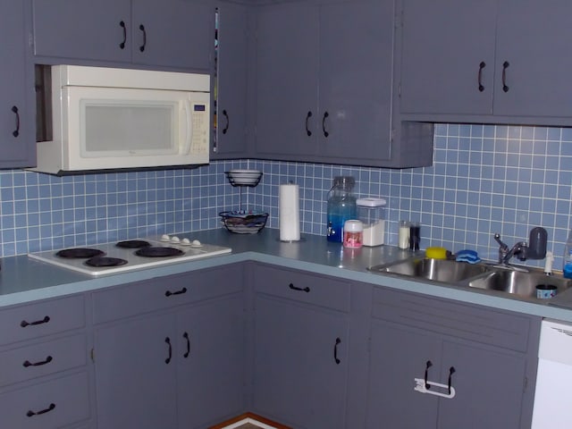 kitchen with white appliances, tasteful backsplash, and sink