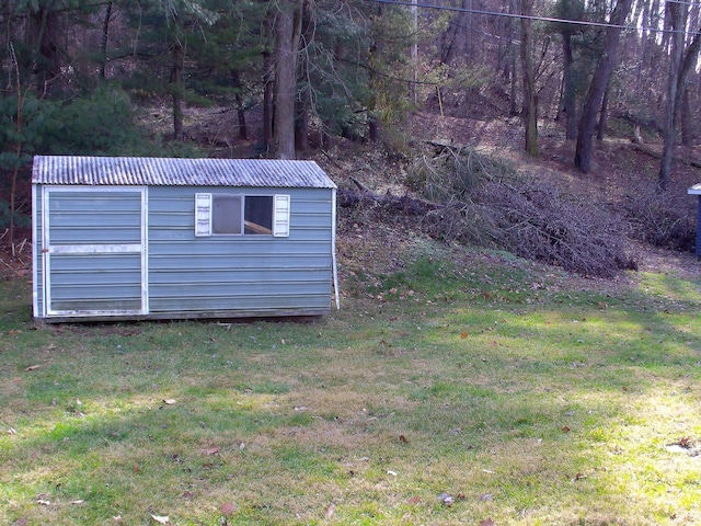 view of outdoor structure featuring a lawn