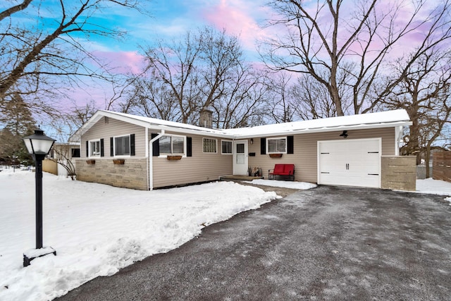 ranch-style house featuring a garage