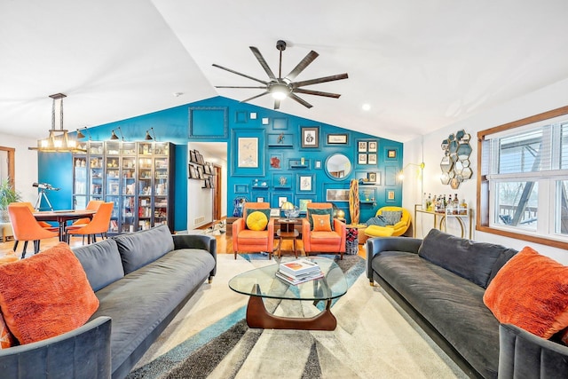 carpeted living room featuring ceiling fan and lofted ceiling