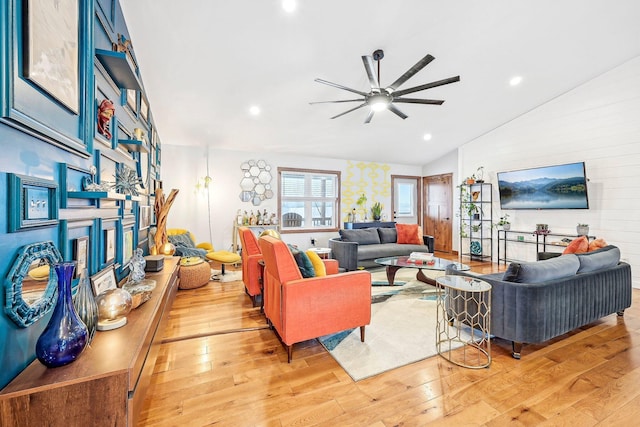 living room featuring lofted ceiling, ceiling fan, and light wood-type flooring