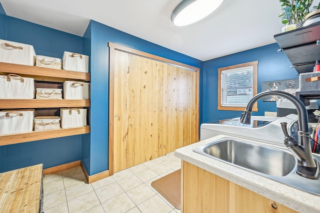 washroom featuring light tile patterned flooring and sink