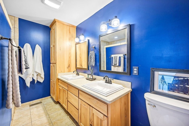 bathroom with tile patterned floors, vanity, and toilet