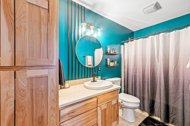 bathroom with tile patterned flooring, vanity, toilet, and a shower with curtain