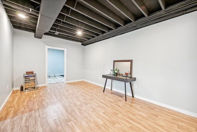 basement with hardwood / wood-style floors