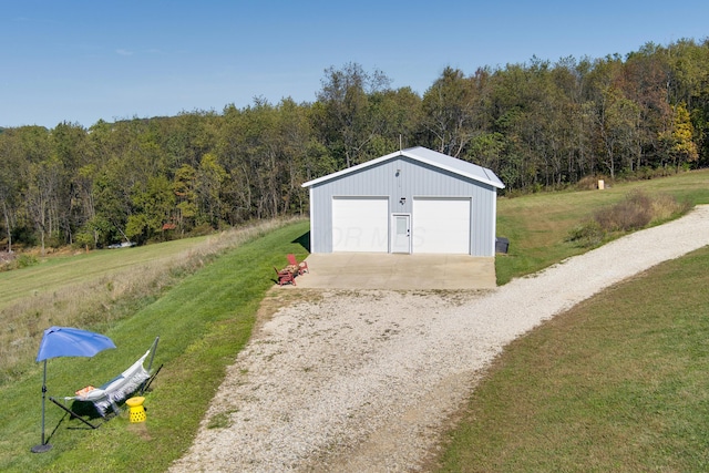 view of outbuilding with a lawn and a garage