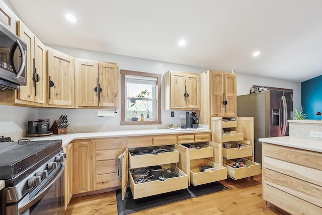 kitchen featuring light wood-type flooring, stainless steel appliances, and light brown cabinetry