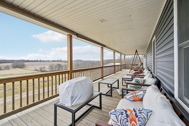 wooden deck with outdoor lounge area and area for grilling