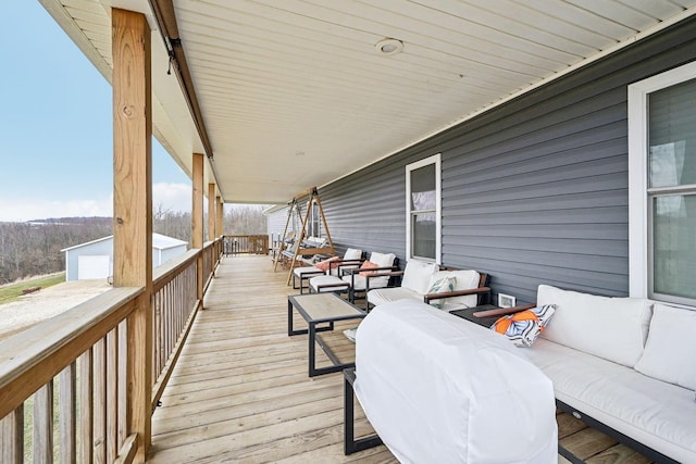 wooden terrace featuring outdoor lounge area