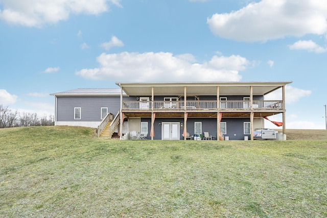 rear view of property with french doors, a yard, and a deck