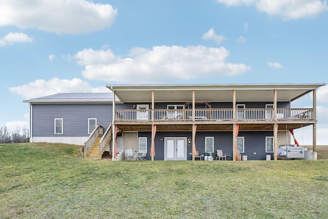 rear view of house with french doors, a yard, and a deck