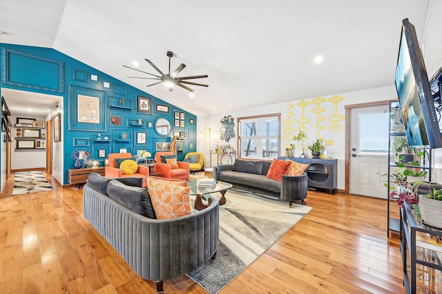 living room featuring plenty of natural light, ceiling fan, lofted ceiling, and light hardwood / wood-style flooring