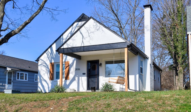 view of front of home featuring a porch and a front lawn