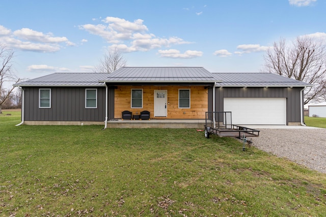 single story home featuring covered porch, a garage, and a front yard