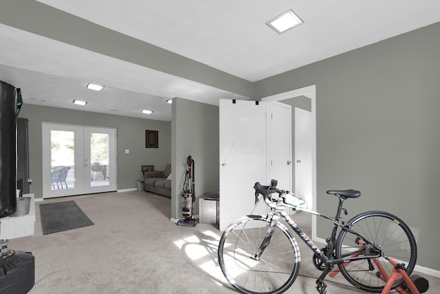 workout area with french doors and light colored carpet