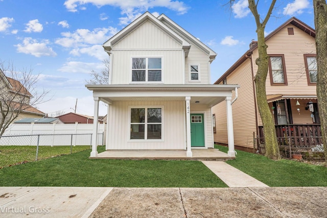 view of front of home with covered porch and a front yard