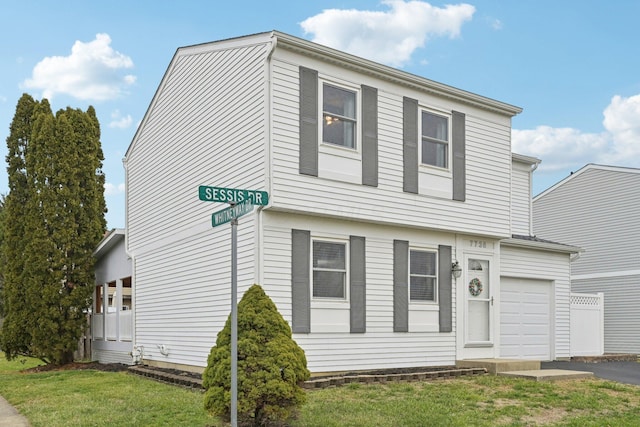 view of front of home featuring a garage and a front lawn