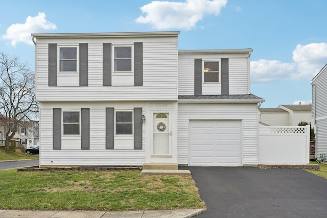 view of front of house with a garage and a front yard