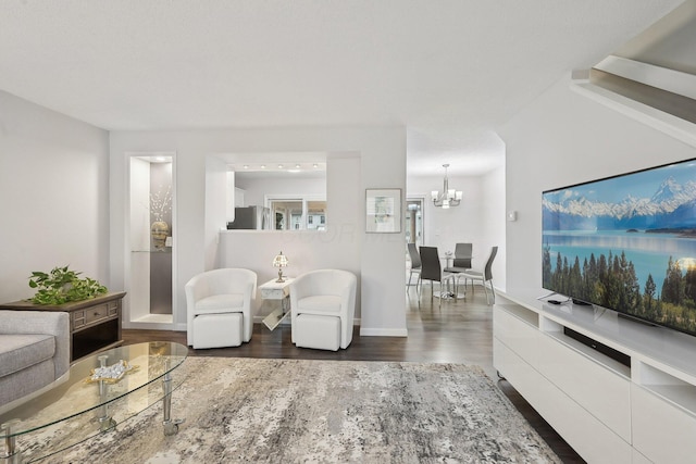 living room featuring dark hardwood / wood-style flooring and a chandelier