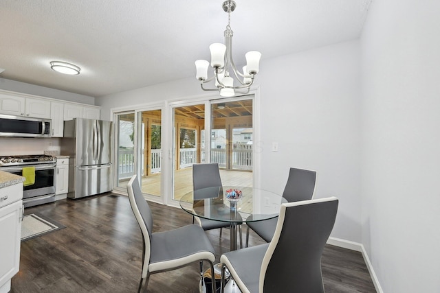 dining room featuring an inviting chandelier, dark hardwood / wood-style floors, and a textured ceiling