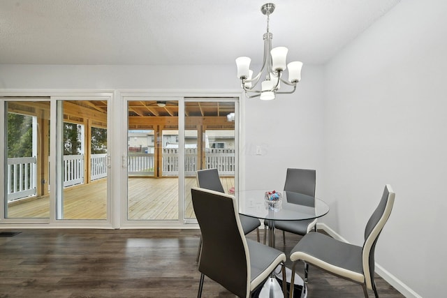 dining room featuring dark wood-type flooring and a notable chandelier