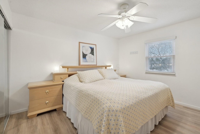 bedroom with a closet, ceiling fan, and light hardwood / wood-style flooring