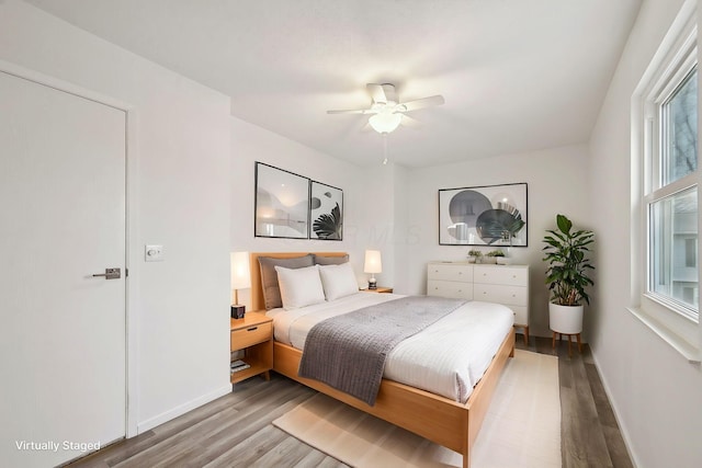 bedroom featuring ceiling fan and light hardwood / wood-style flooring