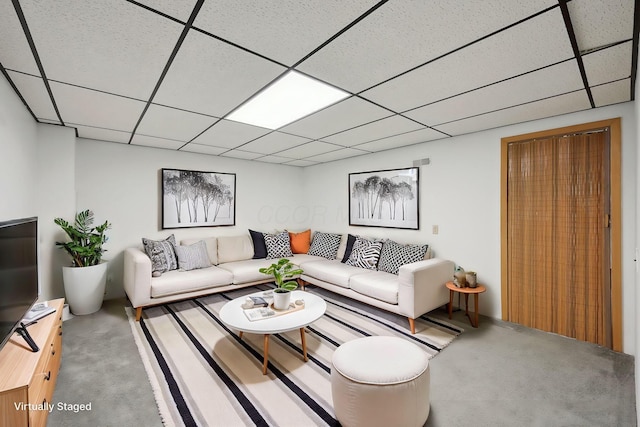 carpeted living room featuring a paneled ceiling