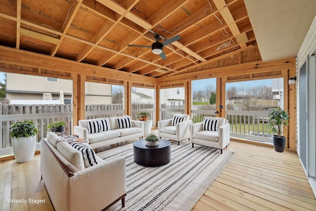 sunroom featuring ceiling fan