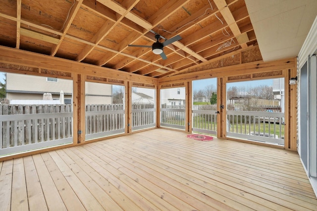 unfurnished sunroom with a healthy amount of sunlight and ceiling fan