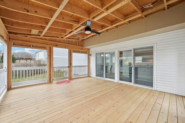 unfurnished sunroom featuring coffered ceiling, a healthy amount of sunlight, and ceiling fan