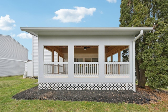 rear view of property featuring a lawn