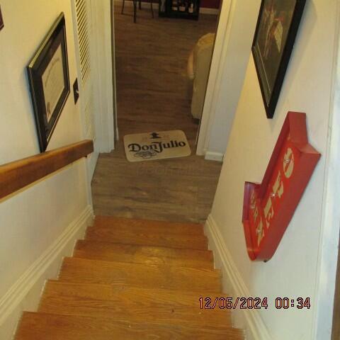 stairs featuring wood-type flooring