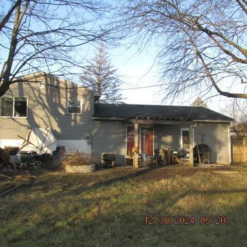 back of house with a lawn