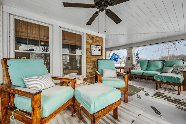 sunroom featuring ceiling fan and lofted ceiling