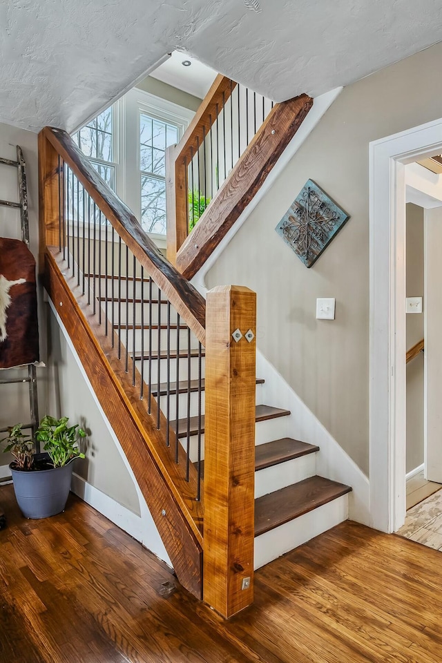 stairs with hardwood / wood-style floors