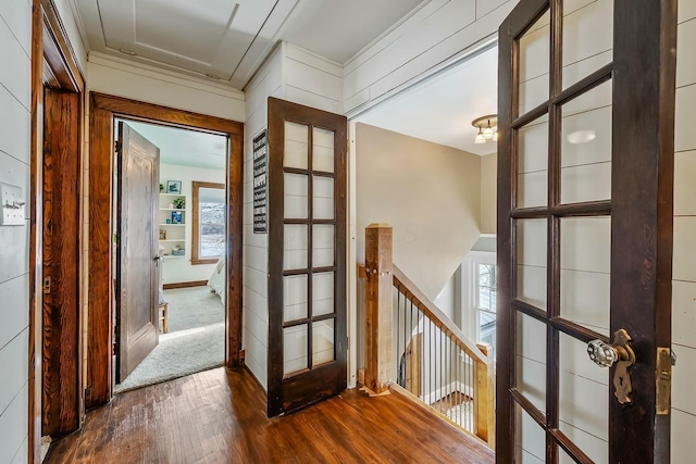 hallway featuring dark hardwood / wood-style floors, a healthy amount of sunlight, and french doors