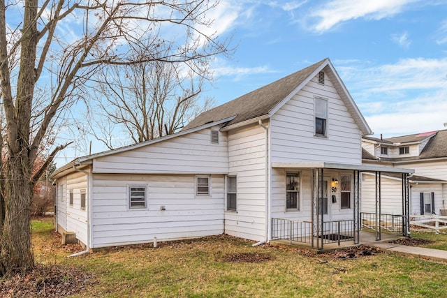 bungalow with covered porch and a front yard