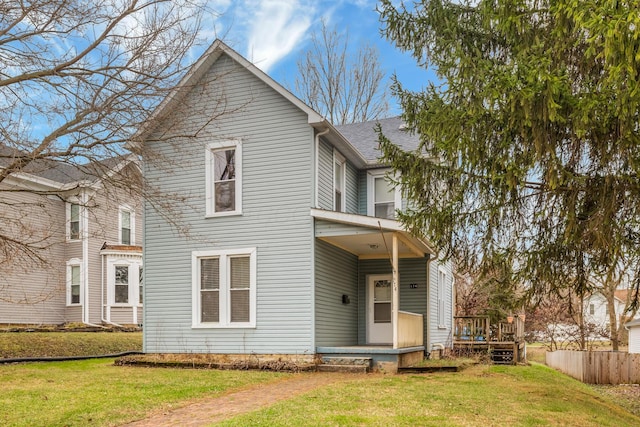 back of house with a yard