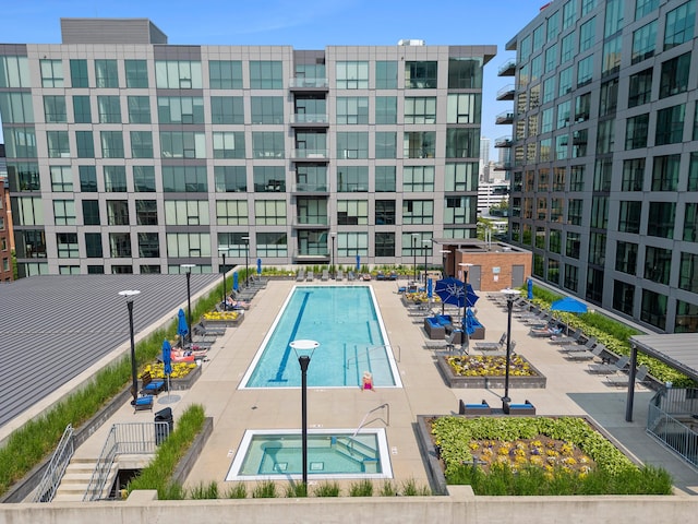 view of swimming pool with a community hot tub