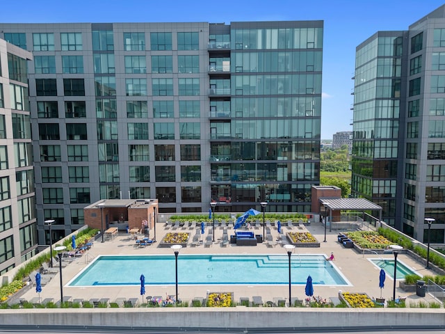 view of pool with a patio area and a city view