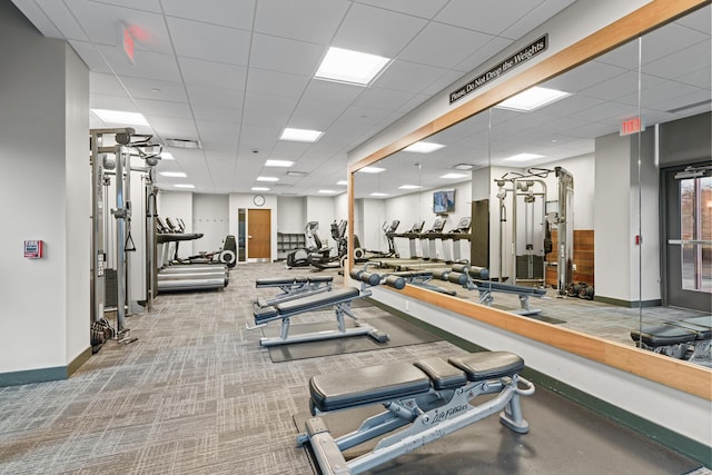 gym with carpet, visible vents, a drop ceiling, and baseboards