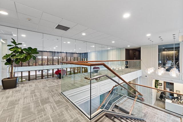 interior space featuring carpet, floor to ceiling windows, and recessed lighting